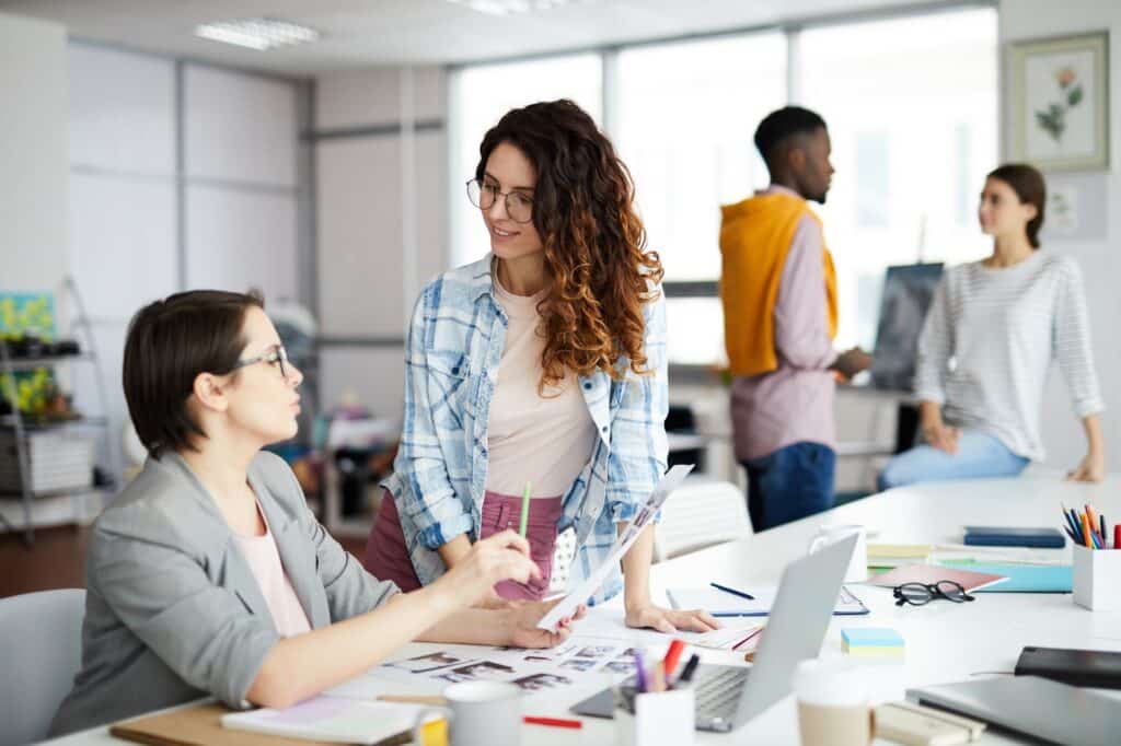 Magazine Editor Talking to Colleague