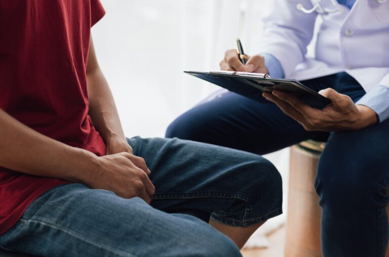 A man suffering from sexual dysfunction visits a doctor for treatment. Male health problem concept.