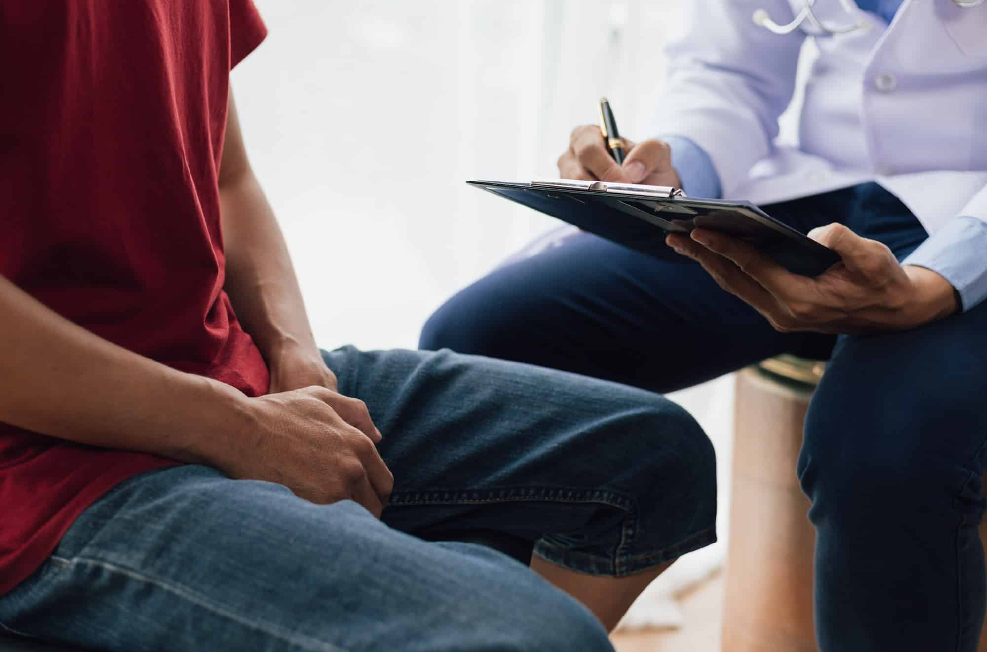 A man suffering from sexual dysfunction visits a doctor for treatment. Male health problem concept.
