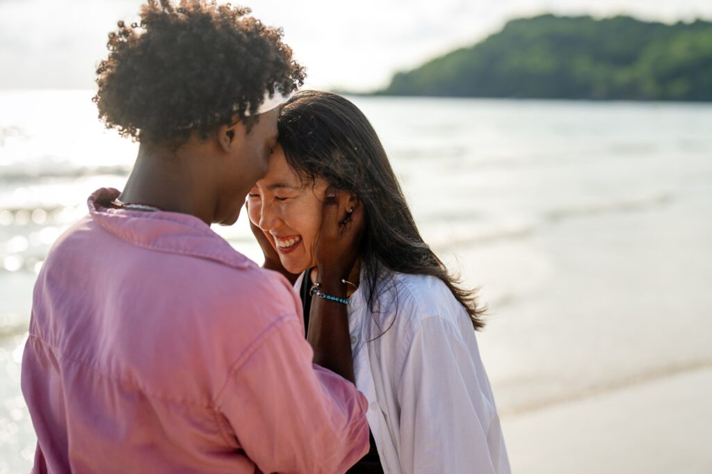 Couple embracing trust and deep connection, enjoying a peaceful and harmonious relationship on beach symbolizing an emotional connection rituals.