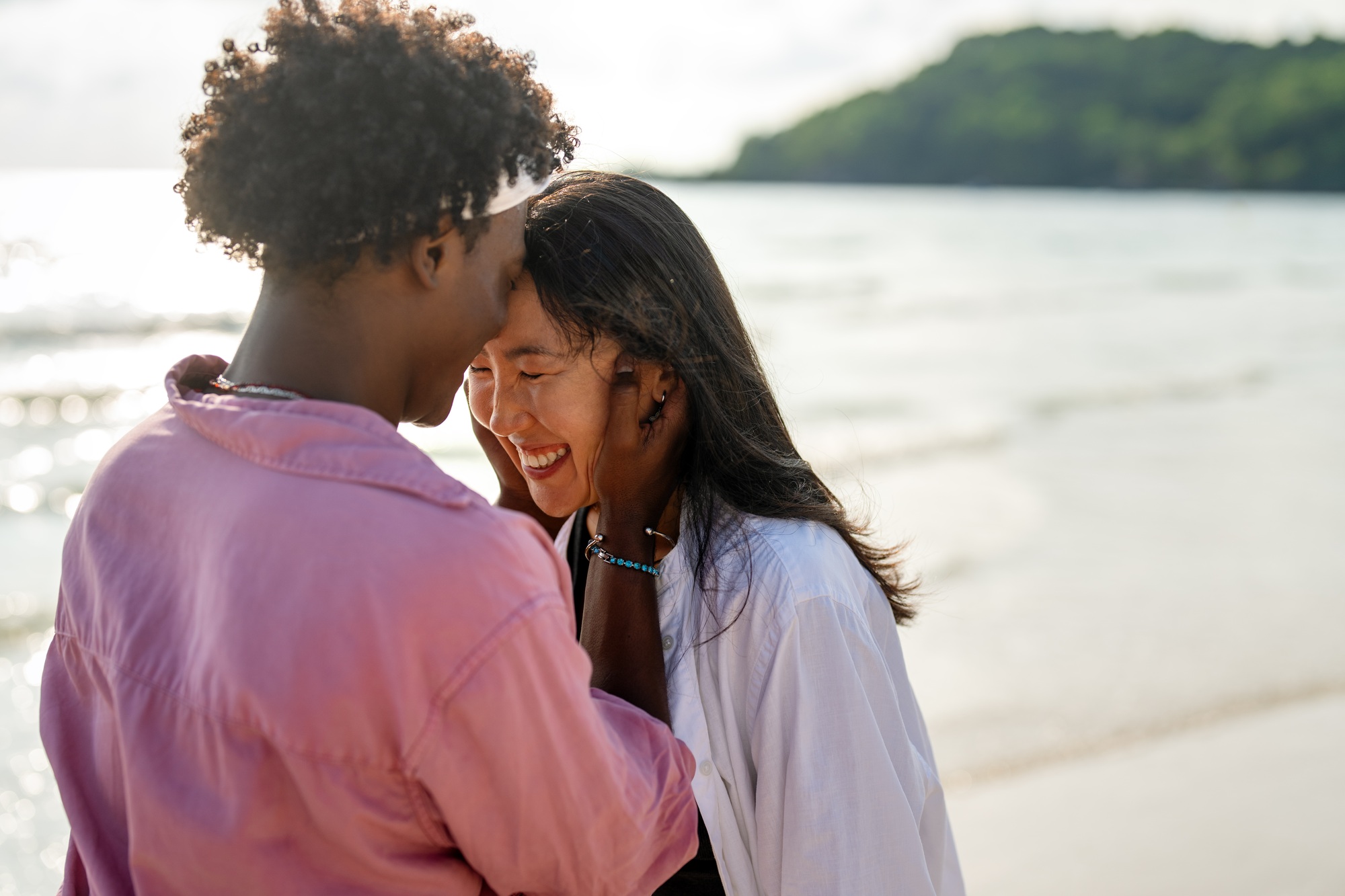 Couple embracing trust and deep connection, enjoying a peaceful and harmonious relationship on beach symbolizing an emotional connection rituals.